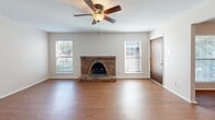 Located at 5115 Cedar Springs Rd in Dallas, TX, this one-bedroom, one-bathroom unit offers a thoughtfully arranged single-story layout that maximizes functionality. The living room serves as the heart of the home, anchored by a classic brick wood-burning fireplace and flanked by two windows that invite natural light and offer views of the surrounding greenery. A ceiling fan overhead adds comfort and a casual, inviting ambiance throughout.

The kitchen is well-appointed with warm wood cabinetry, granite countertops, a stainless steel refrigerator, range, and microwave, complemented by light tile flooring. A door at the end of the kitchen provides convenient outdoor access. The adjoining dining area flows naturally from the kitchen, creating a cohesive space for everyday living.

The bedroom is a comfortable retreat, featuring the same warm wood-look flooring found throughout the unit, a ceiling fan, and a dedicated closet for organized storage. A large window fills the room with natural light while offering a pleasant outdoor view through slatted blinds.

The bathroom includes a tub-shower combo enclosed by sliding glass doors, tile surround with decorative accents, a granite-topped vanity, and tile flooring, offering a clean and functional design. Neutral wall tones and consistent finishes throughout the unit create a cohesive, move-in-ready feel.