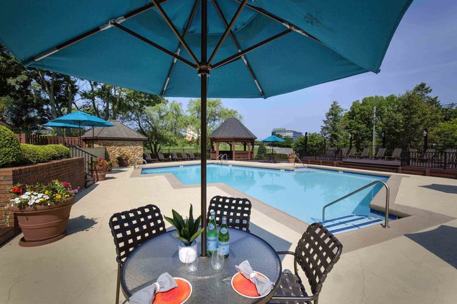 Resort-style pool with dining area - The Willows of Plainview