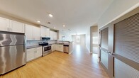 This contemporary 830 square foot apartment offers a well-designed layout with 2 bedrooms and 2 bathrooms. The open-concept living area seamlessly combines the kitchen and living room, creating a spacious feel. The kitchen boasts white cabinetry, stainless steel appliances, and a subway tile backsplash, perfect for culinary enthusiasts.

The primary bedroom, measuring 130 square feet, provides ample space and features plush carpeting and large windows with blinds for natural light control. The second bedroom, also carpeted, offers a cozy retreat. Both bathrooms are modern and functional, with one featuring a combination tub/shower and the other a stand-alone shower.

Throughout the apartment, wood-look flooring adds warmth and elegance to the living spaces. Ceiling fans in multiple rooms ensure good air circulation. The neutral color palette of light gray walls and white trim creates a fresh, clean ambiance that's easy to personalize.

Storage is plentiful with a dedicated closet and additional built-in storage options. The apartment's design maximizes the use of space, making it feel larger than its actual square footage suggests. This well-appointed home offers a perfect blend of style, comfort, and functionality for modern living.