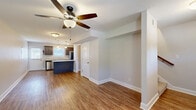 Located in Professional Park Dr in Clarksville, TN, this two-story townhome offers a practical and well-appointed layout across two floors. The exterior features a classic brick façade with covered entry, part of a well-maintained community with ample parking.

The main floor encompasses a combined kitchen and living area. The galley-style kitchen is equipped with dark espresso cabinetry, light granite-look countertops, stainless steel appliances including a refrigerator, dishwasher, and microwave, plus a double-basin sink beneath a window that brings in natural light. Wood-look plank flooring runs throughout the main level, adding warmth and easy maintenance.

Upstairs, two bedrooms are finished with plush carpeting and ceiling fans. The primary bedroom includes a closet and direct access to a bathroom with a dark-toned vanity and wood-look flooring. The second bedroom also features a ceiling fan and a window with natural light. Three full bathrooms serve the home, including clean white tub-surround bathtubs with built-in shelving.

A notable convenience is the dedicated in-unit laundry area on both floors, complete with full-size washer and dryer units. A closet provides additional storage. Neutral tones throughout create a clean, move-in-ready ambiance suited for comfortable everyday living.