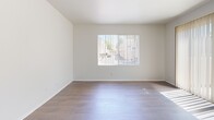 Located at 21311 Adler Dr in Santa Clarita, CA, this single-story, 3-bedroom, 3-bathroom home offers a bright and clean living environment with a thoughtfully designed layout. The open living area features rich hardwood-style flooring and a sliding glass door that floods the space with natural light while providing direct access to an outdoor patio. The kitchen is a standout feature, boasting soaring vaulted ceilings with exposed beams, white cabinetry, a peninsula with a sink, stainless steel appliances including a gas range and refrigerator, and a dishwasher — all finished with a crisp, modern aesthetic. Three well-proportioned bedrooms are finished with soft carpet and vertical blinds, with the primary bedroom offering a generous footprint and sliding glass door access. Each of the three bathrooms maintains a clean, white palette with wood-style flooring, vanities with countertops, and tub-shower combinations. A dedicated laundry area houses a full-sized Whirlpool washer and dryer. Throughout the home, large windows ensure consistent natural light, creating a bright and airy ambiance that complements the neutral tones and clean finishes found in every room.