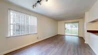 This 710 square foot apartment in Nashville, TN, offers a well-designed living space with one bedroom and one bathroom. The layout maximizes functionality within its compact footprint. The open-concept living area features durable wood-look flooring and large windows that invite natural light, creating a sense of spaciousness. The kitchen boasts modern appliances, including a stainless steel range and refrigerator, complemented by warm wood cabinetry and ample counter space. The bedroom, measuring 150 square feet, provides a cozy retreat with plush carpeting and a closet for storage. The bathroom is equipped with a vanity and a shower/tub combination. A standout feature is the in-unit laundry room, complete with a washer and dryer, enhancing convenience for residents. Throughout the apartment, neutral tones dominate, allowing for personalization. The property's single-story design and sliding glass door suggest potential outdoor access, adding to its appeal for those seeking a low-maintenance lifestyle in a prime Nashville location.