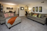 Located at 9123 Grayland Dr in Knoxville, TN, this single-story home offers a practical and comfortable layout across several well-defined living spaces. The living room is generously proportioned, featuring neutral-toned carpet, textured ceilings, and a pair of French doors that allow natural light to flow in while providing direct access to the outdoors. The open layout connects seamlessly to the dining area, which includes a pendant light fixture overhead and a window with views of surrounding greenery, creating a bright and functional space for everyday meals.

The kitchen is efficiently designed in a U-shaped configuration, featuring white cabinetry with ample storage, dark countertops, hardwood-style flooring, and black appliances including a range, dishwasher, and refrigerator. The bedrooms are carpeted and well-lit by windows overlooking the exterior, each offering closet storage. The neutral wall tones throughout lend a clean, cohesive feel to each room.

The bathroom includes hardwood-style flooring, a tub-shower combination, and a vanity with dark stone-style countertops. Overall, the home presents a straightforward, functional design with consistent finishes and comfortable proportions throughout.