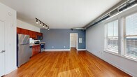 Located in Memphis, TN 38103, this single-floor studio offers a thoughtfully designed open-concept layout that maximizes every square foot. The main living area is defined by warm hardwood floors that run throughout the entire unit, reflecting natural light that pours in through multiple large windows. Exposed silver ductwork runs along the ceiling, lending the space a distinctive industrial-loft character that is complemented by track lighting mounted on a sleek black rail.

The kitchen is integrated seamlessly into the open living space and features rich cherry wood cabinetry, granite countertops, a white subway tile backsplash, and a full suite of stainless steel appliances including a refrigerator, range, microwave, and dishwasher. A door off the main area leads to a closet, providing practical storage solutions.

The full bathroom is clean and well-appointed, showcasing a cherry wood vanity with a granite countertop, a large mirror, and a combined shower-tub enclosure with chrome fixtures and grab bars. Hardwood flooring continues into the bathroom, maintaining a cohesive aesthetic throughout the unit.

The overall ambiance balances urban industrial style with warm, inviting finishes, making this Memphis studio a compelling and functional living space.