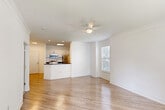Located at 2750 Millerville Rd in Baton Rouge, LA, this well-designed one-bedroom, one-bathroom residence offers a clean, modern aesthetic throughout its single-floor layout. The open-concept living, dining, and kitchen area creates a seamless flow, anchored by light wood-style flooring, crown molding, and a ceiling fan that enhances the airy atmosphere. Natural light pours in through multiple windows fitted with blinds, brightening the entire space.

The kitchen is a functional standout, featuring white cabinetry, dark granite-style countertops, a peninsula with an undermount sink, and a full suite of stainless steel appliances including a refrigerator, range, microwave, and dishwasher. Recessed lighting provides additional illumination throughout the kitchen area.

The bedroom is generously proportioned, with plush carpeting, dual windows, a ceiling fan, and access to multiple closets, offering ample storage. The bathroom is neatly appointed with a tub-shower combo featuring warm stone tile surround, a white vanity, and wood-style flooring.

Additional highlights include a dedicated laundry area with washer and dryer, a private patio for outdoor enjoyment, and a convenient entrance foyer. The overall design is cohesive, bright, and move-in ready.