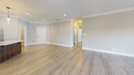 Located at 119 Cornerstone St in Lynchburg, Virginia, this well-designed single-floor home offers 2 bedrooms, 3 bathrooms, and a bonus room across a generously sized floor plan. The open-concept main living area seamlessly connects the living room, dining area, and kitchen, all finished with light wood-tone flooring and neutral wall tones that create a bright, welcoming atmosphere. Crown molding and recessed lighting add refined architectural detail throughout.

The kitchen is a standout feature, showcasing rich dark wood cabinetry, light granite countertops with subtle veining, a classic subway tile backsplash, stainless steel appliances, and a central island with elegant pendant lighting overhead — ideal for both cooking and entertaining.

The bedrooms are carpeted for comfort, each equipped with ceiling fans and ample closet space. The primary bedroom includes dual closets and is generously proportioned. The three bathrooms are finished with tile flooring, granite-topped vanities with dark wood cabinetry, and clean white fixtures, including a tub-shower combination.

Additional spaces include a laundry room, utility room, hallway, and five closets providing abundant storage. French doors in the living area bring in natural light and offer outdoor access, rounding out this thoughtfully designed home.