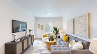 This thoughtfully designed single-floor residence offers a clean, contemporary aesthetic throughout, with white walls, light wood-style flooring, and an abundance of natural light from multiple windows overlooking lush greenery. The open-concept living area provides a welcoming atmosphere, anchored by generous wall space ideal for art displays and featuring ample room for comfortable seating arrangements. A galley-style kitchen is a standout feature, equipped with stainless steel appliances including a range, microwave, and refrigerator, complemented by warm taupe cabinetry, white quartz countertops, an undermount sink, and a subway tile backsplash. The layout flows efficiently from the kitchen into the main living space. The bedrooms are calm and restful, each benefiting from natural light through blinds-fitted windows and offering a serene outdoor tree-line view. Both bathrooms are finished to a high standard, featuring white quartz vanity tops, undermount sinks, light wood cabinetry with matte black hardware, and large mirrors. One bathroom includes a shower-tub combination. Additional highlights include a walk-in closet accessible from the kitchen area, a private entrance, and a consistent modern design language carried throughout every room of the residence.