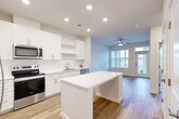 This contemporary 610 square foot apartment in La Plata, MD offers a thoughtfully designed living space. The heart of the home is an open-concept kitchen and living area, showcasing a modern aesthetic with crisp white cabinetry, stainless steel appliances, and a functional island with built-in storage. Recessed lighting and a warm wood-tone floor unify the space, creating a seamless flow throughout.

The single bedroom, measuring 150 square feet, features a large window that floods the room with natural light. A ceiling fan adds both style and comfort. The bathroom boasts a clean, white design with a spacious vanity and a combination tub-shower.

Storage is abundant, with a walk-in closet offering adjustable wire shelving. The apartment's neutral color palette and minimalist design allow for personal touches and versatile decorating options. Large windows in the living area and bedroom provide views of the surrounding area and ample daylight.

Energy-efficient appliances, including a microwave and dishwasher, complete the modern kitchen. The overall design emphasizes functionality and style, making efficient use of the compact 610 square foot floor plan. This apartment is ideal for those seeking a contemporary living space with all the essentials in a convenient La Plata location.