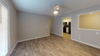 Located at 239 Blair Dr in Clarksville, Tennessee, this single-floor home offers a well-organized layout with a consistent, neutral design palette throughout. The entryway opens into a spacious living area finished with wood-look luxury vinyl plank flooring and soft gray walls, creating a bright and welcoming atmosphere. A ceiling-mounted light fixture adds functional illumination to the space, which flows directly into the kitchen. The kitchen is equipped with white cabinetry, light countertops, a double-basin sink, and black appliances including a range, dishwasher, and refrigerator, all set atop matching wood-look flooring. The bedrooms feature plush wall-to-wall carpeting and are generously sized. The primary bedroom includes a ceiling fan with light, multiple windows fitted with white horizontal blinds for natural light control, and access to two closets. Additional rooms offer carpeted or wood-look flooring with ample outlets and neutral wall tones. The bathroom presents a clean, functional design with a tub-shower combination, a white vanity with storage, and wood-look tile flooring. Throughout the home, white trim and six-panel doors provide a cohesive, tidy finish.
