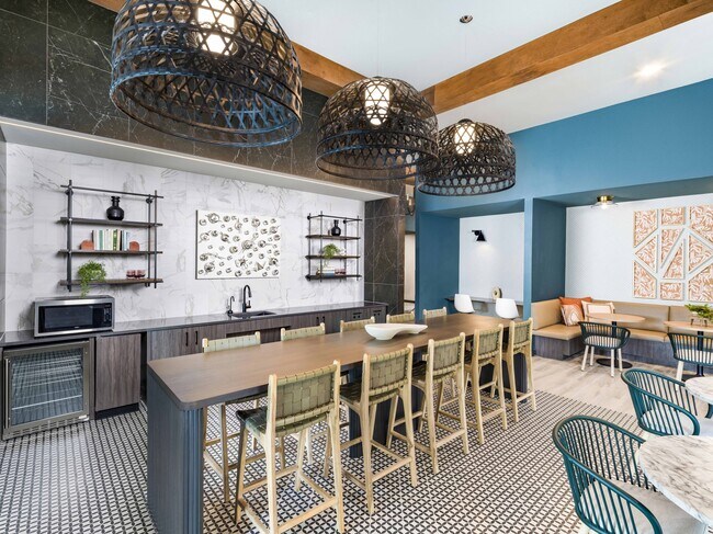 Discover the heart of community living at Modera Georgetown's expansive clubroom, complete with a cozy coffee bar. - Modera Georgetown