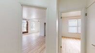 Located at 530 S Kingsley Dr in Los Angeles' vibrant Koreatown neighborhood, this single-floor residence combines classic architectural character with modern updates. Light hardwood flooring flows consistently throughout the space, lending warmth and cohesion to every room.

The living area is a standout, featuring an exposed brick accent wall, elegant arched doorways, and large multi-pane windows that flood the room with natural light. Ornate crown molding adds a refined touch, while a ceiling fan provides year-round comfort. Mirrored closet doors and generous built-in storage are found throughout the bedrooms, maximizing functionality. Each bedroom benefits from natural light courtesy of well-placed windows with blinds, and ceiling fans for added convenience.

The galley-style kitchen is equipped with sleek gray shaker cabinetry, white countertops, and stainless steel appliances including a gas range and over-the-range microwave. The bathroom features a clean, minimalist design with a pedestal sink, gold-tone fixtures, a soaking tub with overhead shower, a recessed niche, and a leaded-glass window that introduces natural light while maintaining privacy. The overall ambiance of the space is bright, airy, and move-in ready.