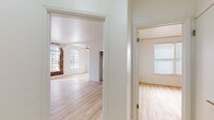 Located at 530 S Kingsley Dr in Los Angeles' vibrant Koreatown neighborhood, this single-floor residence combines classic architectural character with modern updates. Light hardwood flooring flows consistently throughout the space, lending warmth and cohesion to every room.

The living area is a standout, featuring an exposed brick accent wall, elegant arched doorways, and large multi-pane windows that flood the room with natural light. Ornate crown molding adds a refined touch, while a ceiling fan provides year-round comfort. Mirrored closet doors and generous built-in storage are found throughout the bedrooms, maximizing functionality. Each bedroom benefits from natural light courtesy of well-placed windows with blinds, and ceiling fans for added convenience.

The galley-style kitchen is equipped with sleek gray shaker cabinetry, white countertops, and stainless steel appliances including a gas range and over-the-range microwave. The bathroom features a clean, minimalist design with a pedestal sink, gold-tone fixtures, a soaking tub with overhead shower, a recessed niche, and a leaded-glass window that introduces natural light while maintaining privacy. The overall ambiance of the space is bright, airy, and move-in ready.