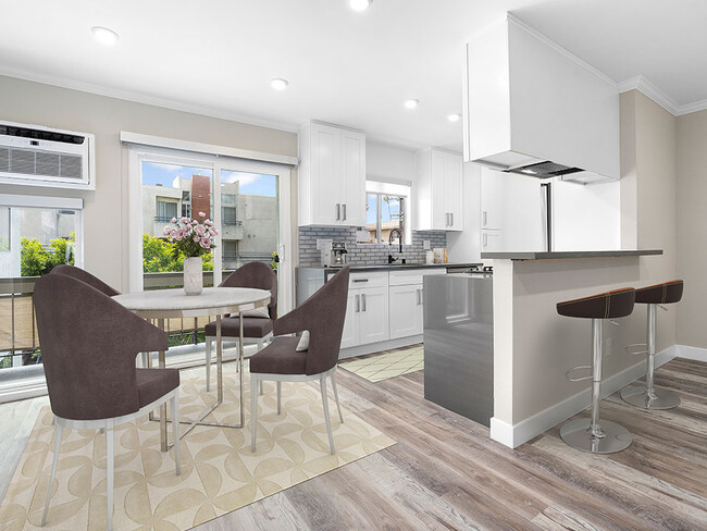 Hardwood floored dining room near bar seating in kitchen. - 1249 South Bundy