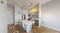 Located at 3007 Petty Rd in Durham, NC, this one-bedroom, one-bathroom residence offers a well-designed layout that maximizes every square foot. The open-concept living and kitchen area serves as the heart of the home, featuring warm hardwood-style flooring, neutral tones, and abundant natural light streaming through large windows with elegant drapery. A ceiling fan adds comfort to the inviting living space, which also provides access to an outdoor area through a glass-panel door.

The kitchen is outfitted with stainless steel appliances — including a range, microwave, and dishwasher — complemented by gray shaker-style cabinetry, white quartz countertops, and a classic subway tile backsplash. A peninsula island with seating for multiple guests serves as both a dining and gathering space, illuminated by modern pendant lighting overhead.

The bedroom offers a tranquil retreat with plush carpeting, a ceiling fan, and a dedicated closet for storage. Soft, neutral wall tones and natural light from a bright window create a calming ambiance.

The full bathroom features large-format tile flooring, gray shaker vanity cabinetry with a white countertop, and a full soaking tub with a shower, finished with clean white tile surround. Every room reflects a cohesive, contemporary aesthetic suited for comfortable everyday living.