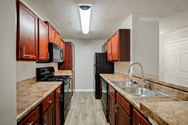 Cherry Wood Upgrade: Cherrywood cabinets, black appliances, updated lighting - xCrestmark Apartment Homes