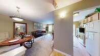 Located at 201 Regency Dr in Bloomingdale, IL, this single-floor, 2-bedroom, 2-bathroom residence offers a thoughtfully designed layout that maximizes comfort and functionality. The living room serves as the heart of the home, featuring plush carpeting, warm neutral tones, and a bright window that invites natural light and outdoor views of surrounding greenery. The open and welcoming atmosphere makes it ideal for both relaxing and entertaining.

The combined dining room and kitchen area is a practical highlight of the space. The kitchen is equipped with ample cabinetry, white appliances, a stainless steel sink, and durable hardwood-style flooring. The adjacent dining area features a sliding glass door that fills the room with natural light and provides a pleasant outdoor view, adding an airy quality to everyday meals.

The generously sized primary bedroom offers a tranquil retreat, complete with carpeting, natural light from a large window, and neutral wall tones. The second bedroom is equally comfortable, also featuring carpet and warm neutral walls.

The two bathrooms are well-appointed: one features a walk-in glass-door shower with a wood-toned vanity, while the second includes a full bathtub and tile flooring. A connecting hallway ties the layout together efficiently, completing a cohesive and livable floor plan.