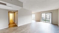Located at 4355 Sepulveda Blvd, this 2-bedroom, 1-bathroom unit offers a thoughtfully designed single-floor layout with a clean, neutral aesthetic throughout. Light wood-style flooring flows seamlessly across the living areas, complementing the warm beige walls and textured ceilings that add subtle character to each room.

The open living room is bright and airy, benefiting from abundant natural light through a large window and a full-width sliding glass door that opens to a private balcony with outdoor views of the surrounding neighborhood. A second window further enhances the sense of light and openness in the space.

The galley-style kitchen is efficiently laid out with white cabinetry, gray countertops, a classic subway tile backsplash, and stainless steel appliances including a refrigerator, dishwasher, electric range, and microwave. The kitchen connects conveniently to the rest of the unit via a hallway.

The spacious primary bedroom features a large window with slatted blinds, allowing for controlled natural light, and continues the light wood flooring found throughout. The bathroom includes a vanity with a dark countertop, white cabinetry with brushed nickel hardware, and a separate water closet. The overall ambiance is clean, bright, and move-in ready.