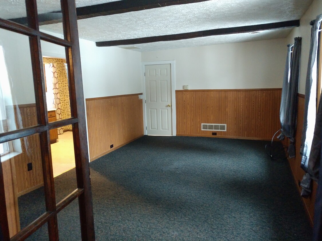 Living room with dark wood beams on ceiling - 5748 Old French Rd