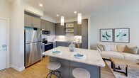 Located at 1325 Boland Pl in Richmond Heights, MO, this thoughtfully designed 2-bedroom, 2-bathroom residence offers a comfortable and functional single-floor layout. The open-concept kitchen is a standout feature, equipped with gray shaker-style cabinetry, stainless steel appliances, a granite-topped island with bar seating, and modern pendant lighting — all flowing seamlessly onto warm hardwood-style flooring. The living area connects naturally to the kitchen, creating an ideal space for everyday living and entertaining.

Both bedrooms are carpeted and generously sized, each featuring ceiling fans and large windows that invite abundant natural light and views of the surrounding greenery. The primary bedroom includes a private en-suite bathroom with a granite vanity, gray cabinetry, and stylish brushed nickel fixtures. The second bathroom offers a full tub-shower combination with hardwood-style flooring and a matching granite vanity.

The residence also includes a dedicated in-unit laundry room with full-size washer and dryer, as well as two closets for additional storage. Throughout the space, a neutral color palette of soft whites and warm grays creates a clean, modern aesthetic that is both inviting and versatile.