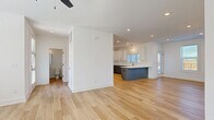 Located in Duluth, GA, this well-appointed two-story home offers 3 bedrooms, 5 bathrooms, and a thoughtfully designed floor plan spread across two levels. The main floor features an open-concept living and dining area that flows seamlessly into a modern kitchen. The kitchen is outfitted with two-tone cabinetry — white upper cabinets paired with slate-gray lowers — a herringbone tile backsplash, quartz countertops, stainless steel appliances, a kitchen island, and pendant lighting over a light hardwood floor. A built-in hallway nook with paneled walls and black coat hooks adds functional charm near the entry. The main level also includes a patio and convenient access to a utility and laundry room. Upstairs, the three bedrooms are finished with plush carpet, ceiling fans, and ample natural light from large windows. The primary bedroom connects to an en suite bathroom featuring a double-sink vanity with gray cabinetry, a glass-enclosed shower, and matte black fixtures. Seven closets — including walk-in options with wire shelving — provide generous storage throughout. Two staircases, a balcony, and a second patio complete the layout. The exterior features white brick, modern architectural lines, and landscaped grounds with open green views beyond.