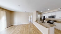 Located at 10500 Sea Pearl Cv in San Diego, CA, this well-appointed 2-bedroom, 2-bathroom single-story residence offers a thoughtfully designed floor plan with clean finishes throughout. The open-concept living and dining area is bathed in natural light from a large sliding glass door fitted with vertical blinds, and features light wood-style flooring that extends seamlessly through the main living spaces.

The kitchen is a standout feature, outfitted with crisp white cabinetry, granite countertops, stainless steel appliances including a gas range, microwave, and refrigerator, and a peninsula with a sink that opens to the dining and living areas — ideal for everyday functionality.

Both bedrooms are comfortably sized; the primary bedroom offers multiple windows that invite natural light and is finished with plush carpet flooring. The bathrooms are well-appointed with white vanity cabinetry, clean countertops, and a walk-in glass shower. Two closets provide ample storage, and a hallway connects the private sleeping quarters to the main living area.

An attached garage with a tankless water heater adds practical convenience, while an additional storage area with wire shelving offers extra organizational space. Neutral warm-toned walls and recessed lighting throughout lend the home a bright, cohesive ambiance.