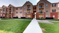 Located at 5793 Hoover Falls Dr in Westerville, Ohio, this single-floor residence is part of a thoughtfully designed multi-story building that blends brick and neutral siding exteriors for a timeless, classic aesthetic. The building's facade features arched entryways, black shuttered windows, and private balconies on upper levels, all set against well-manicured green lawns with clean concrete walkways connecting the grounds. The exterior reflects a community-oriented layout with open green spaces and a welcoming approach path leading to the building entrance. The architecture emphasizes a traditional style with layered rooflines and structured symmetry, giving the property a polished and cohesive appearance. The surrounding grounds are neatly landscaped, contributing to an inviting and well-kept environment. Situated in Westerville, OH, residents benefit from access to a vibrant suburban community with nearby amenities, schools, and parks. The property's design prioritizes both functionality and curb appeal, making it a notable address within its neighborhood.