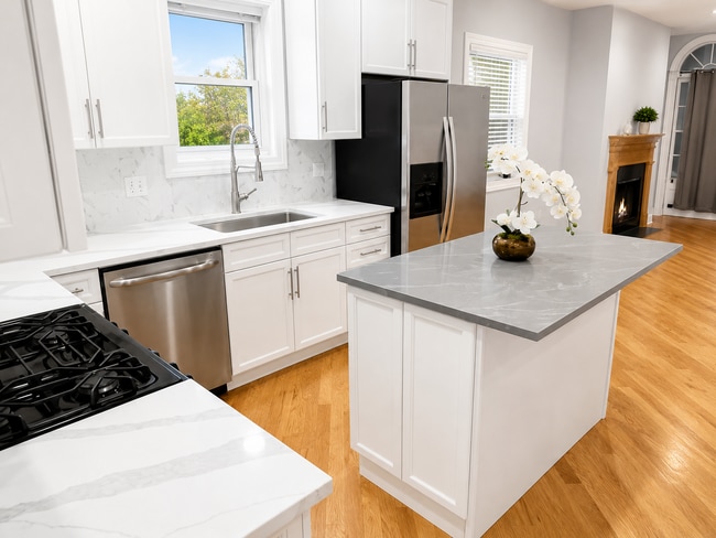 New kitchen with deep sink, backsplash, and quartz countertops - 3513 North Reta Avenue