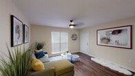 Located in the Leto neighborhood of Tampa, FL, this single-floor residence at 3132 W Lambright St offers a thoughtfully designed layout with comfortable, functional spaces throughout. The living room serves as the heart of the home, featuring rich wood-look flooring, neutral warm-toned walls, and a ceiling fan with light fixture. A large window fitted with horizontal blinds allows natural light to fill the room, creating a bright and welcoming atmosphere. The space is accessible directly through a front entry door, and wall-mounted shelving adds a decorative touch. The kitchen is outfitted with white cabinetry, granite-look countertops, a stainless steel sink, and a dishwasher, with additional storage provided by a full-size pantry or closet door. Wood-look flooring continues seamlessly from the living area into the kitchen. The bedroom is carpeted for comfort and features warm, neutral tones, a ceiling fan, blinds-covered window, and wall art, creating a restful retreat. The doll's-eye overview confirms a compact, efficient floor plan that connects all areas logically. Overall, the space presents a clean, modern aesthetic with consistent finishes that offer a comfortable living environment in a convenient Tampa location.