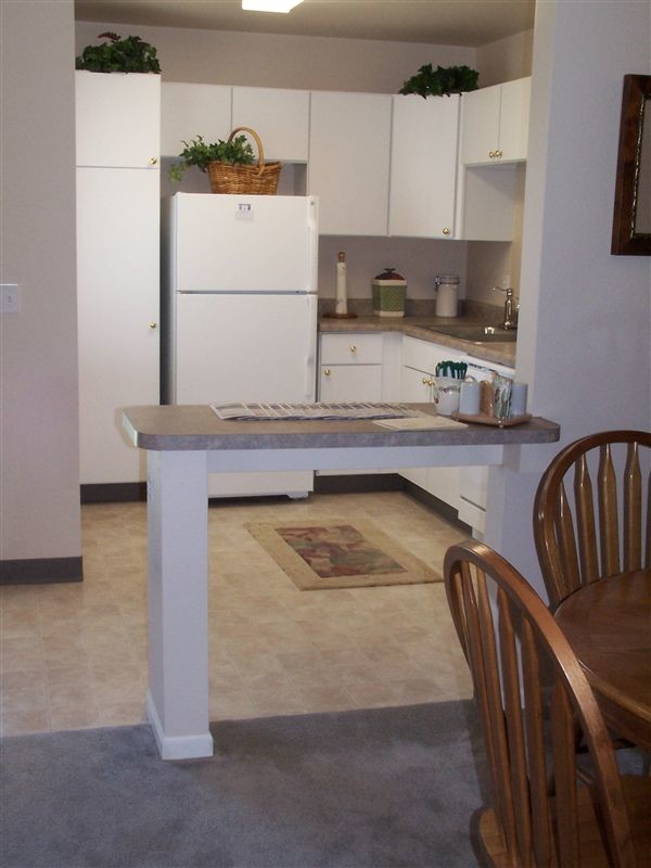 The Cottage kitchen is open to the dining and living room. - Bayberry Farms Village