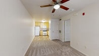 Located at 5601 Natomas Blvd in Sacramento, CA, this two-bedroom apartment offers a practical and efficiently designed single-floor layout. The open-concept living area flows directly into the kitchen, creating a connected and functional common space. The living room features neutral carpet flooring and a ceiling fan with light fixture, contributing to a bright and airy feel. Two six-panel doors lead to the bedrooms, each finished with plush carpet flooring. The primary bedroom is a comfortable size and includes a ceiling fan, while a window with blinds allows for natural light. A second bedroom provides additional flexibility for use as a guest room or home office.

The kitchen is equipped with light wood cabinetry, speckled laminate countertops, a double-basin stainless steel sink, a white electric range with coil burners, an over-the-range microwave, and a full-size refrigerator. Wood-look vinyl flooring anchors the kitchen space. The bathroom features wood-look plank flooring and clean white finishes. Two closets provide dedicated storage, and an in-unit laundry area adds everyday convenience. The unit's neutral color palette and consistent finishes throughout create a cohesive and livable environment.