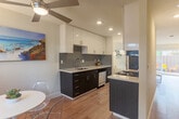 Located at 1901 Halford Ave in Santa Clara, CA, this two-story home offers four bedrooms and four bathrooms thoughtfully distributed across two floors. The ground floor hosts the main living areas, including a bright, open kitchen outfitted with two-tone cabinetry — white uppers and dark wood lowers — complemented by grey subway tile backsplash, white quartz countertops, and stainless steel appliances. The kitchen flows naturally toward the living room, which features a fireplace and light-toned hardwood floors that carry throughout the home. A compact dining area with a window overlooking the outdoors adds a welcoming touch. The upper floor houses the bedrooms, each finished with the same warm hardwood flooring and ample natural light from well-placed windows. Six closets provide generous storage across the home. The four bathrooms are clean and functional, featuring walk-in showers with glass enclosures. A private outdoor patio offers a peaceful retreat with views of surrounding mature trees. Additional conveniences include an in-unit laundry room and two staircases connecting the floors. The overall aesthetic is clean, modern, and well-maintained, making this Santa Clara home a functional and comfortable residence.