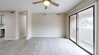 Located at 100 Hunter Hill Rd in Tarboro, NC, this well-appointed 2-bedroom, 2-bathroom single-floor residence offers a clean, modern living experience. Light gray luxury vinyl plank flooring runs consistently throughout, complementing the neutral warm-beige walls and crisp white trim found in every room.

The living room is a comfortable, open space featuring a ceiling fan and sliding glass door that leads to a private balcony, filling the room with natural light. Adjacent to the living area, the dining room connects seamlessly to the galley-style kitchen, which is equipped with gray cabinetry, light laminate countertops, a stainless steel refrigerator, stainless range, and dishwasher — all set beneath under-cabinet lighting.

A central hallway with a textured ceiling guides residents to both bedrooms. The spacious primary bedroom features dual sliding closets providing generous storage, a ceiling fan, and its own bathroom access. The second bedroom is equally well-sized, with a ceiling fan, natural window light, and closet space. Both bathrooms are functional and clean, each featuring a tub-shower combination with white surround panels and hardwood-style flooring.

Additional highlights include a dedicated laundry area, utility room, entrance foyer, and multiple closets distributed throughout, ensuring practical storage solutions across the entire residence.