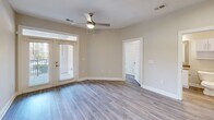 Located at 111 Grove Park Dr in Mooresville, NC, this well-appointed 2-bedroom, 2-bathroom single-story residence offers a thoughtfully designed open-concept layout. The kitchen serves as a central hub, featuring white shaker cabinetry, white subway tile backsplash, stainless steel appliances including a French-door refrigerator, electric range, microwave, and dishwasher, along with a large peninsula with a quartz-style countertop and pendant lighting — ideal for both meal prep and casual dining. The kitchen flows seamlessly into the living room, which is highlighted by light wood-look LVP flooring, neutral toned walls, a ceiling fan, and French doors that invite natural light and provide access to the outdoors. The primary bedroom offers generous space with its own ceiling fan, while the second bedroom features a bright window with outdoor views. The primary bathroom is equipped with both a glass-enclosed walk-in shower with white subway tile surround and a soaking tub. The second bathroom includes a full tub-shower combo, toilet, and overhead cabinetry. A dedicated laundry room houses a full-size side-by-side washer and dryer with overhead wire shelving. The hallway and closet complete this efficiently organized, move-in-ready home.