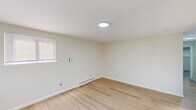 Located at 1127 Ward St in Chester, PA, this 2-bedroom, 1-bathroom unit offers a clean, modern living environment across a single floor. The interior is finished with light-toned hardwood flooring that runs consistently throughout, complementing the neutral, off-white walls to create a bright and cohesive aesthetic.

The living room serves as a welcoming entry point, featuring two windows with blinds that allow natural light to fill the space, along with a ceiling light fixture and baseboard heating. The kitchen is well-appointed with crisp white shaker-style cabinetry, brushed nickel hardware, a stainless steel sink with a modern faucet, a stainless steel range, and a full-size refrigerator — providing functional and attractive workspace.

Both bedrooms are comfortably sized with neutral walls, light hardwood floors, and baseboard heating. The primary bedroom includes a double sliding-door closet, while the second bedroom also features a built-in closet for ample storage. Each room benefits from natural light through windowed walls fitted with blinds.

The bathroom includes a clean white tub/shower enclosure with built-in shelving. Two hallways connect the rooms efficiently, contributing to a practical and well-organized floor plan. The overall ambiance is clean, updated, and move-in ready.