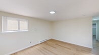 Located at 1127 Ward St in Chester, PA, this 2-bedroom, 1-bathroom unit offers a clean, modern living environment across a single floor. The interior is finished with light-toned hardwood flooring that runs consistently throughout, complementing the neutral, off-white walls to create a bright and cohesive aesthetic.

The living room serves as a welcoming entry point, featuring two windows with blinds that allow natural light to fill the space, along with a ceiling light fixture and baseboard heating. The kitchen is well-appointed with crisp white shaker-style cabinetry, brushed nickel hardware, a stainless steel sink with a modern faucet, a stainless steel range, and a full-size refrigerator — providing functional and attractive workspace.

Both bedrooms are comfortably sized with neutral walls, light hardwood floors, and baseboard heating. The primary bedroom includes a double sliding-door closet, while the second bedroom also features a built-in closet for ample storage. Each room benefits from natural light through windowed walls fitted with blinds.

The bathroom includes a clean white tub/shower enclosure with built-in shelving. Two hallways connect the rooms efficiently, contributing to a practical and well-organized floor plan. The overall ambiance is clean, updated, and move-in ready.