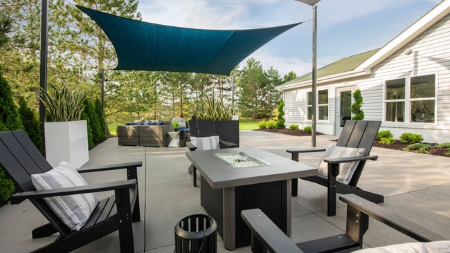 Disfrute del aire libre en nuestro patio con asientos cubiertos y muebles cómodos, operado profesionalmente por Highlands Vista Group. - Atlas North