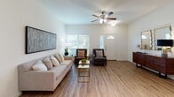Located at 975 E Main St in Allen, Texas, this single-floor residence offers a thoughtfully designed layout that balances comfort and functionality. The open-concept living area greets visitors with warm wood-look flooring, neutral toned walls, and generous natural light streaming through large windows dressed with horizontal blinds. A ceiling fan with light fixture enhances airflow and ambiance, while a front entry door with a transom window adds a welcoming architectural touch.

The kitchen is equipped with rich, dark espresso cabinetry, granite-look countertops, a tiled backsplash, and a full suite of stainless steel appliances including a side-by-side refrigerator with ice maker, dishwasher, and range. Under-cabinet lighting highlights the workspace, and the open layout connects the kitchen seamlessly to the main living area.

The bedroom is a serene retreat featuring wood-look flooring, a ceiling fan, and a large window offering pleasant outdoor views. Ample space accommodates generous furniture arrangements, and the room provides a calm, restful atmosphere.

The bathroom is finished with a granite-topped vanity, dark wood cabinetry for storage, wood-look flooring, and a large mirror. Additional overhead cabinetry provides practical storage solutions.

Throughout the residence, consistent finishes and a cohesive neutral palette create a clean, modern aesthetic that is both inviting and functional.