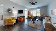 Located at 807 Central Park Circle in Kalamazoo, Michigan, this single-floor residence offers a thoughtfully designed layout with a seamless flow between living, dining, and sleeping areas. The open living room is a standout space, featuring dark hardwood-style flooring, a ceiling fan, and an abundance of natural light from large windows with views to the outdoors. A wall-mounted flat-screen TV and generous seating area make it ideal for both relaxing and entertaining.

The kitchen is equipped with dark espresso cabinetry, granite countertops, and a full suite of stainless steel appliances, including a refrigerator, range, and built-in microwave. Warm wood-tone flooring completes the functional and stylish cooking space. A separate dining nook with dark hardwood-style floors provides a cozy area for meals.

Both bedrooms are carpeted and well-sized, each featuring ceiling fans and windows that bring in natural light. The primary bedroom offers a calm, neutral palette with ample space. The two bathrooms are finished with dark vanity cabinetry, granite countertops, wood-style flooring, and tub-shower combinations with clean white tile surrounds. The overall design is cohesive, contemporary, and comfortable throughout.