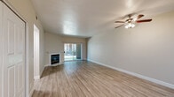 Located at 7200 Gloria Dr in Sacramento, CA, this single-story residence offers three bedrooms and three bathrooms within a thoughtfully designed floor plan. Throughout the home, light-toned luxury vinyl plank flooring creates a clean, cohesive aesthetic that complements the neutral warm-beige walls and crisp white trim.

The living room serves as the heart of the home, highlighted by a white-mantled fireplace and large sliding glass doors that invite abundant natural light and provide direct access to the outdoors. The kitchen is efficiently laid out with ample white cabinetry, light quartz-style countertops, a stainless steel refrigerator, electric range, and a skylight that brightens the workspace.

Each of the three bedrooms offers a comfortable, well-proportioned space with neutral walls, natural light from windows fitted with blinds, and generous closet storage including double bifold closet doors. The primary bedroom provides a quiet retreat with its own dedicated bathroom.

The three bathrooms are finished in a clean, bright style, each featuring wood-look flooring, white fixtures, and tub-shower combinations. The entrance provides a welcoming transition into the home. Sliding glass doors in multiple rooms connect the interior to outdoor greenery, enhancing the sense of openness throughout this well-maintained Sacramento residence.