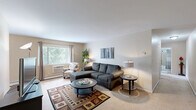Located at 6127 Eastman Ave in Midland, Michigan, this 2-bedroom, 1-bathroom single-floor residence offers a practical and comfortable layout designed for everyday living. The entrance leads into a hallway that connects all areas of the home seamlessly.

The living room is a bright, carpeted space featuring a large window that frames views of the surrounding greenery, filling the room with natural light and a relaxed ambiance. Adjacent to the living area, the combined kitchen and dining room features warm wood cabinetry with ample upper and lower storage, a double sink, and full appliances including a range and refrigerator, all set on light tile flooring.

Both bedrooms are carpeted and well-proportioned, each benefiting from natural light through sizeable windows with outdoor views. The primary bedroom offers generous space for furnishings, while the second bedroom includes a wide louvered closet, providing excellent built-in storage. With four closets distributed throughout the unit, storage is a notable feature of this home.

The bathroom is cleanly finished with white tile flooring, a tub-shower combination, a vanity with cabinet storage, and straightforward, functional fixtures. A connecting hallway ties all rooms together efficiently, making this a well-organized and easy-to-navigate residence.