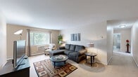 Located at 6127 Eastman Ave in Midland, Michigan, this 2-bedroom, 1-bathroom single-floor residence offers a practical and comfortable layout designed for everyday living. The entrance leads into a hallway that connects all areas of the home seamlessly.

The living room is a bright, carpeted space featuring a large window that frames views of the surrounding greenery, filling the room with natural light and a relaxed ambiance. Adjacent to the living area, the combined kitchen and dining room features warm wood cabinetry with ample upper and lower storage, a double sink, and full appliances including a range and refrigerator, all set on light tile flooring.

Both bedrooms are carpeted and well-proportioned, each benefiting from natural light through sizeable windows with outdoor views. The primary bedroom offers generous space for furnishings, while the second bedroom includes a wide louvered closet, providing excellent built-in storage. With four closets distributed throughout the unit, storage is a notable feature of this home.

The bathroom is cleanly finished with white tile flooring, a tub-shower combination, a vanity with cabinet storage, and straightforward, functional fixtures. A connecting hallway ties all rooms together efficiently, making this a well-organized and easy-to-navigate residence.