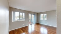 Located at 200 Greenbriar Cir in Petaluma, CA, this well-appointed one-bedroom, one-bathroom unit offers a functional and comfortable layout across a single floor. The living room is a highlight of the space, showcasing gleaming hardwood floors that reflect abundant natural light streaming in through multiple windows and a sliding glass door that opens to a private patio, creating a seamless indoor-outdoor connection. The kitchen is efficiently designed with white cabinetry, granite-style countertops, stainless steel appliances including a gas range, microwave, refrigerator, and dishwasher, all complemented by the same warm hardwood flooring. The bedroom offers a cozy, carpeted retreat with a window that brings in natural light and a six-panel door for privacy. A second carpeted room, accessible via the hallway, provides additional flexible living space. The bathroom features a clean, white tiled tub-shower combination with chrome fixtures. Neutral-toned walls throughout the unit create a calm, versatile backdrop. Hallways connect the rooms efficiently, contributing to the smart use of the overall footprint. This unit combines practical design with bright, welcoming interiors in a residential Petaluma neighborhood.