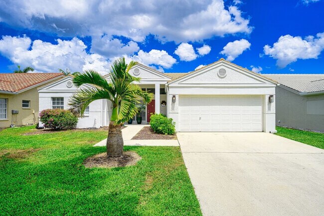 Property view of 2 car garage and driveway parking - 7311 Mill Pond Cir