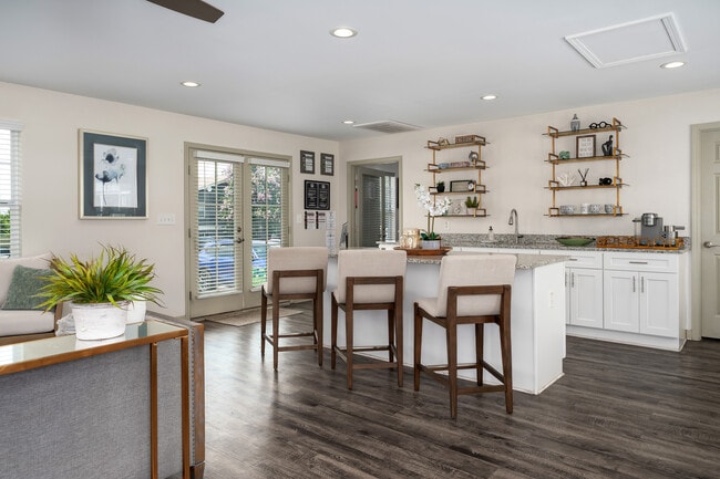 Entertain with ease in kitchens featuring bar seating and separate dining areas, professionally operated by Highlands Vista Group. - Arbours at Victoria Place