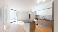 Located on NE 112th St in Miami, FL, this single-floor residence showcases a clean, modern design characterized by bright white walls, light wood flooring, and an open layout that promotes a sense of spaciousness throughout. The living area is a standout feature, benefiting from abundant natural light streaming through large floor-to-ceiling sliding glass doors that open to an outdoor space, offering views of the surrounding urban landscape.

The kitchen is well-appointed with a central island featuring a dark stone countertop and wood-toned cabinetry, complemented by matching lower cabinets and crisp white upper cabinetry. A textured tile backsplash adds visual depth, while stainless steel appliances — including a refrigerator, range, and microwave — provide a polished, functional finish. A brass-toned faucet at the dedicated sink area adds a refined touch.

The bedrooms are bright and airy, each with black-framed windows offering urban views and continuing the light wood flooring throughout. Two bathrooms serve the space: one features a floating wood vanity with a dark stone countertop, a large mirror, and a tub-shower combination with dark tile surround; the other offers a double-sink vanity with matching stone countertops and tiled shower walls, providing a practical and stylish finish.