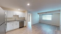 Located at 1012 Shiloh Way in Morrisville, NC, this single-floor unit offers a clean, modern design with an open-concept living and kitchen area. Light wood-style flooring runs throughout, creating a cohesive and airy feel across the space.

The kitchen is well-appointed with crisp white cabinetry, granite countertops, a stainless steel dishwasher, electric range, and over-the-range microwave. It flows seamlessly into the living area, which is brightened by multiple windows with blinds and benefits from recessed lighting overhead.

The bedroom includes sliding glass doors that open to a private balcony with wooded views, providing a peaceful outdoor retreat. A second bedroom features a large window that allows ample natural light to fill the room.

Two bathrooms are present in the unit. One is a full bath equipped with a granite-topped vanity, tub-shower combination, and a stacked washer and dryer tucked conveniently within the space. The second is a three-quarter bath with a granite vanity, single-sink, and a glass-door shower. Both bathrooms feature wood-style flooring consistent with the rest of the unit.

Overall, the space presents a bright, neutral palette with modern finishes throughout, making it a functional and comfortable single-level home.