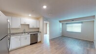 Located at 1012 Shiloh Way in Morrisville, NC, this single-floor unit offers a clean, modern design with an open-concept living and kitchen area. Light wood-style flooring runs throughout, creating a cohesive and airy feel across the space.

The kitchen is well-appointed with crisp white cabinetry, granite countertops, a stainless steel dishwasher, electric range, and over-the-range microwave. It flows seamlessly into the living area, which is brightened by multiple windows with blinds and benefits from recessed lighting overhead.

The bedroom includes sliding glass doors that open to a private balcony with wooded views, providing a peaceful outdoor retreat. A second bedroom features a large window that allows ample natural light to fill the room.

Two bathrooms are present in the unit. One is a full bath equipped with a granite-topped vanity, tub-shower combination, and a stacked washer and dryer tucked conveniently within the space. The second is a three-quarter bath with a granite vanity, single-sink, and a glass-door shower. Both bathrooms feature wood-style flooring consistent with the rest of the unit.

Overall, the space presents a bright, neutral palette with modern finishes throughout, making it a functional and comfortable single-level home.