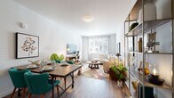 This well-designed single-floor residence offers a seamless blend of comfort and functionality across a thoughtfully arranged floor plan. The open-concept living and dining area serves as the heart of the home, featuring warm wood-look flooring, crisp white walls, and generous natural light streaming through large windows with views of surrounding greenery. The living space accommodates both a full dining setup and a comfortable lounge area, with an open shelving unit providing stylish division between zones.

The kitchen is outfitted with white shaker-style cabinetry, stainless steel appliances including a refrigerator, microwave, and range, and a light stone countertop with a breakfast bar peninsula that connects seamlessly to the living area.

The primary bedroom is a serene retreat with plush carpeting, large windows, and ample room for a sitting area. A second bedroom offers similar comfort with built-in closet storage and carpeted flooring, while a separate den or office space provides flexibility for work or leisure. Two full bathrooms serve the residence — one featuring a soaking tub with shower combination and white vanity cabinetry, and a second with a streamlined vanity and wood-look flooring. The overall ambiance is light, airy, and welcoming throughout.