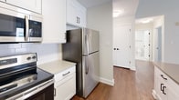This contemporary 1-bedroom apartment, located at 3131 Walnut St in Philadelphia, offers 790 square feet of thoughtfully designed living space. The open floor plan maximizes the sense of spaciousness, with high ceilings and large windows allowing ample natural light to flood the interior. Rich hardwood floors run throughout, adding warmth and sophistication to the space.

The kitchen is a highlight, featuring sleek white cabinetry, stainless steel appliances, and a functional layout. The living area seamlessly connects to the kitchen, creating an ideal space for entertaining or relaxing. The bedroom, measuring 180 square feet, provides a comfortable retreat with built-in closet space.

The bathroom showcases a modern aesthetic with subway tile, a stylish vanity, and a shower/tub combination. Additional amenities include a hallway for added privacy and storage options. The apartment's single floor layout enhances accessibility and ease of movement.

Large windows in the living area and bedroom offer views of the surrounding cityscape, while a sliding glass door leads to a private balcony, perfect for enjoying fresh air or city views. The property's location in the heart of Philadelphia ensures convenient access to urban amenities and attractions.
