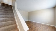 Located at 30 Dry Creek Rd in Goodlettsville, Tennessee, this two-story, 2-bedroom, 2-bathroom home offers a functional and well-organized layout spread across two floors. The main level features a living room and a separate dining room, both finished with rich hardwood-style flooring that adds warmth to the neutral, light-toned walls. A staircase with a white railing connects the floors, and textured ceilings are found throughout. The galley-style kitchen is efficiently designed with dark cabinetry, granite-look countertops, a double sink, and white appliances including a range, refrigerator, and dishwasher, all paired with wood-look flooring. A utility room and additional storage round out the lower level. Upstairs, both bedrooms are carpeted and receive natural light through large windows. The spacious primary bedroom includes multiple closets, offering generous storage. Each bathroom is appointed with dark vanity cabinetry, granite-look countertops, a tub-shower combination, and hardwood-style flooring. With five closets distributed throughout the home, storage is a notable strength. The overall aesthetic is clean, neutral, and move-in ready, making this Goodlettsville home a practical and comfortable residence.